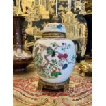 A LATE 19TH CENTURY CHINESE FAMILLE VERTE PORCELAIN URN CONVERTED TO A LAMP BASE