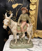 A ROYAL DUX BOHEMIA MODEL OF A BOY ON A DONKEY