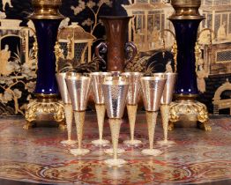 STUART DEVLIN: A SET OF EIGHT STERLING SILVER AND PARCEL GILT CHAMPAGNE FLUTES 1968