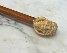 A 19TH CENTURY WALKING CANE WITH MARINE IVORY HANDLE