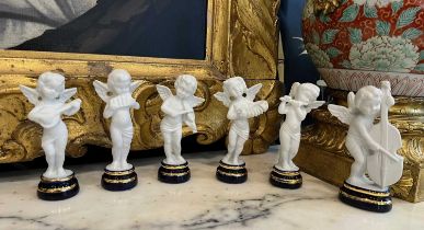 A SET OF SIX LIMOGES PORCELAIN FIGURES OF CHERUB MUSICIANS