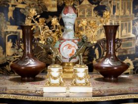 A FINE PAIR OF 19TH CENTURY LOUIS XVI STYLE GILT AND PATINATED BRONZE FIGURAL CANDELABRA