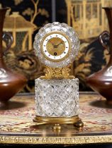 AN EARLY 19TH CENTURY FRENCH EMPIRE PERIOD CUT CRYSTAL GLASS AND ORMOLU MANTEL CLOCK