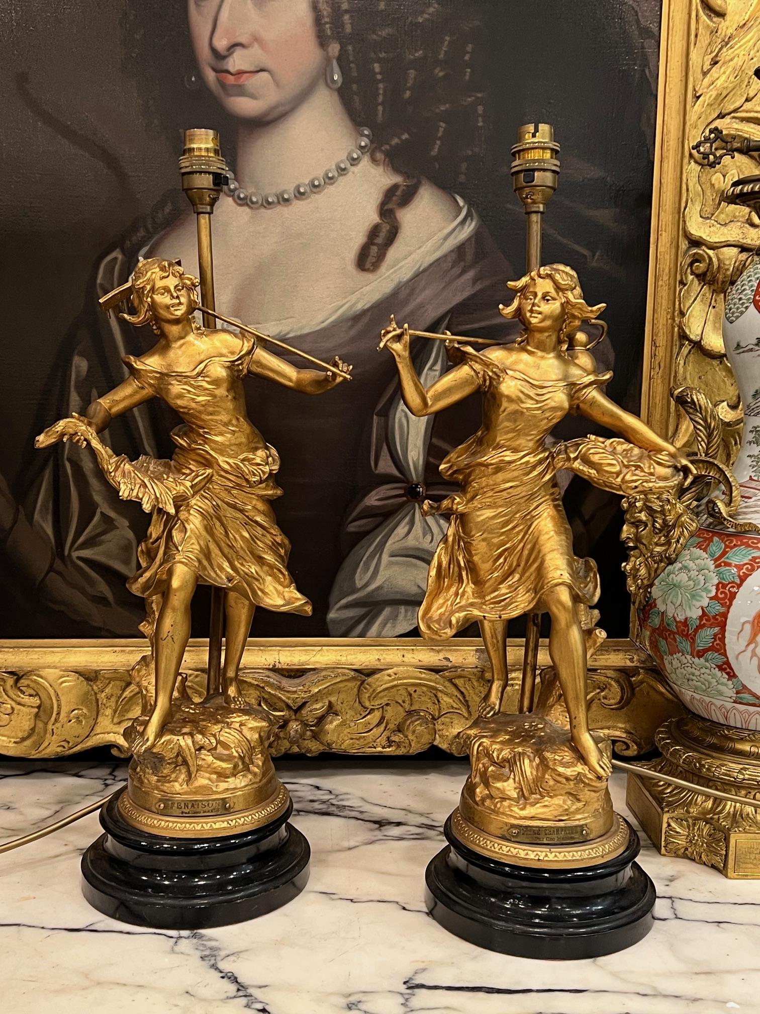 AFTER GEORGES MAXIM (1885-1940): A PAIR OF GILT METAL FIGURAL LAMP BASES
