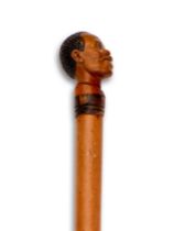 A FINE LATE 19TH / EARLY 20TH CENTURY NOVELTY WALKING CANE CARVED WITH A MAN'S HEAD