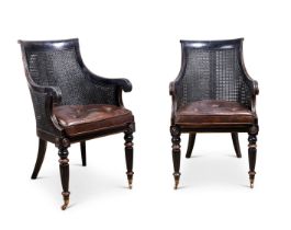 A PAIR OF REGENCY STYLE CANED LIBRARY ARMCHAIRS