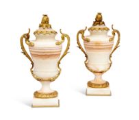 A PAIR OF 19TH CENTURY FRENCH ALGERIAN ONYX AND ORMOLU MOUNTED URNS AND COVERS