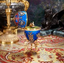 A LARGE FABERGE STYLE DIAMOND ENCRUSTED, ENAMEL AND SILVER GILT SURPRISE EGG