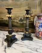 A FINE PAIR OF EARLY 19TH CENTURY EMPIRE PERIOD GILT AND PATINATED BRONZE CANDLESTICKS