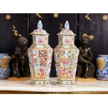 A LARGE PAIR OF EARLY 19TH CENTURY CHINESE CANTON FAMILLE ROSES VASES AND COVERS