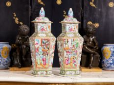 A LARGE PAIR OF EARLY 19TH CENTURY CHINESE CANTON FAMILLE ROSES VASES AND COVERS