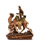 AN EARLY 20TH CENTURY ORIENTALIST PORCELAIN MODEL OF A LION HUNTER