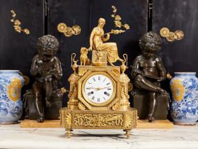 A RARE EARLY 19TH CENTURY EMPIRE PERIOD GILT BRONZE MANTEL CLOCK DEPICTING 'THE SPINNER'