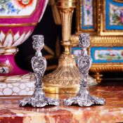 A PAIR OF FABERGE STYLE SILVER CANDLESTICKS IN DISPLAY CASE