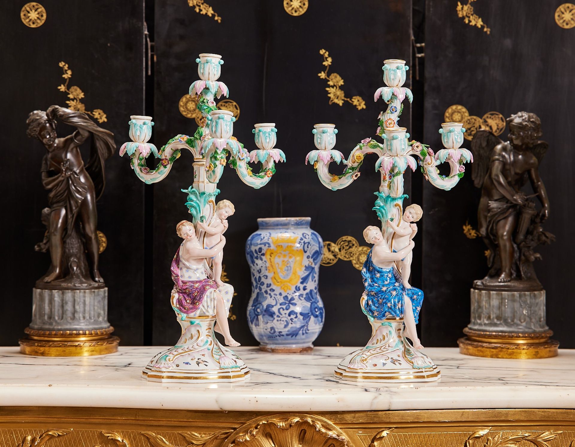 MEISSEN: A PAIR OF 19TH CENTURY PORCELAIN FLOWER ENCRUSTED AND FIGURAL CANDELABRA