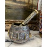 A 19TH CENTURY CAIROWARE SILVER INLAID BRONZE PESTLE AND MORTAR WITH QURANIC SCRIPT