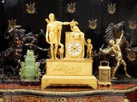 AN EARLY 19TH CENTURY FRENCH EMPIRE PERIOD GILT BRONZE MANTEL CLOCK