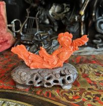 AN EARLY 20TH CENTURY CHINESE CORAL FIGURE