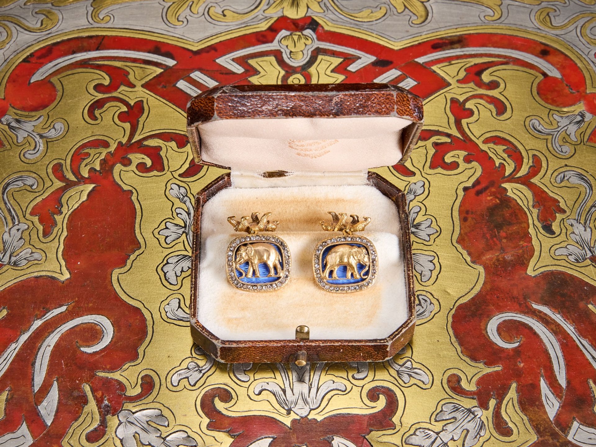 A PAIR OF FABERGE STYLE DIAMOND ENCRUSTED, SILVER GILT AND ENAMELLED CUFFLINKS