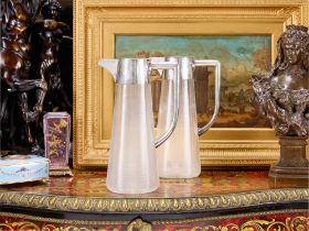A PAIR OF EARLY 20TH CENTURY AUSTRIAN SILVER AND GLASS CLARET JUGS