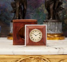 CARTIER: A 1930'S SILVER AND LEATHER TRAVELLING CLOCK IN ORIGINAL CASE