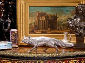 A STERLING SILVER MODEL OF A FOX