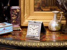 AN ART DECO PERIOD SILVER TRAVELLING CLOCK SIGNED 'HARRODS', C.1932