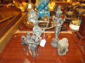 Four Eastern Patinated Metal Figures and a Buddha Head