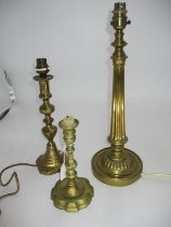 Two Brass Lamps and a Candlestick