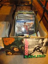 Box of LPs and 45s including The Beatles, The Clash, Marillion