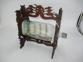 Model Ship Agnes in Bottle within a Fretwork Carved Wood Stand
