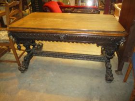 Victorian Gothic Carved Oak Library Table having a Frieze Drawer and Lion Mask Corners and Supports,