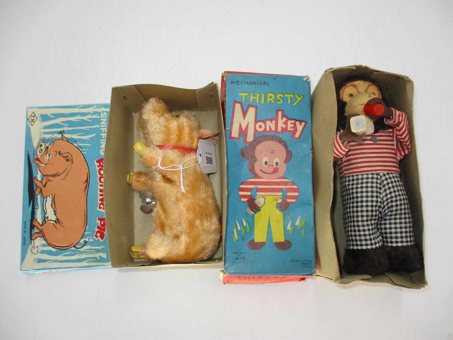 Japanese Wind Up Snuffing Rooting Pig and a Mechanical Thirsty Monkey, Both Boxed