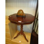 A Small Clock and a Pedestal Table