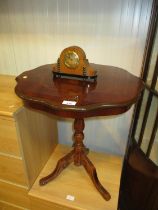 A Small Clock and a Pedestal Table