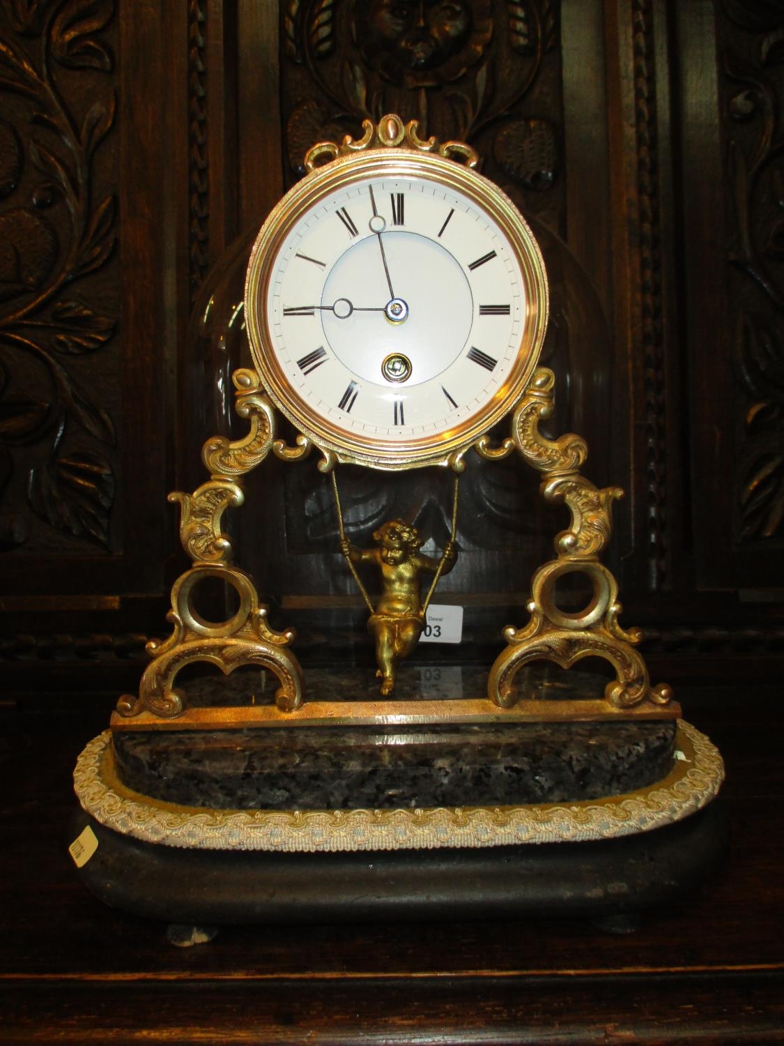 Victorian Gilt Metal Mantel Clock having a Cherub in Swing Pendulum and Glass Dome