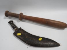 A KUKRI TOGETHER WITH A LARGE WOODEN TRUNCHEON