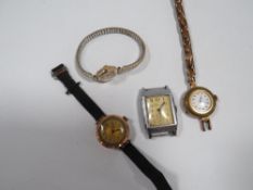 FOUR VINTAGE WATCHES TO INCLUDE 9 CARAT GOLD CASED EXAMPLE ON FABRIC STRAP