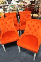 A SET OF FOUR MODERN UPHOLSTERED ORANGE CHAIRS