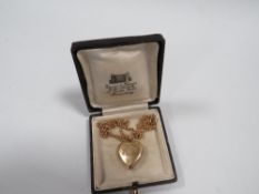 AN ANTIQUE LOCKET MARKED 9CT BACK AND FRONT