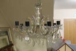 AN EIGHT BRANCH CRYSTAL CHANDELIER TOGETHER WITH MATCHING WALL LIGHTS
