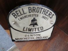 A BELL BROTHERS (MANCHESTER 1927) DENTON LIMITED CAST METAL SIGN MOUNTED ON BOARD WITH HANDLE