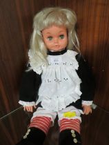 A VINTAGE DRESSED SOFT BODIED STYLE DOLL HEIGHT APPROX 56CM