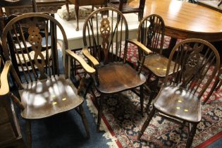 A SET OF FOUR OAK WHEELBACK CHAIRS