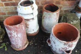 FOUR TERRACOTTA PLANTERS TO INCLUDE THREE CHIMNEY POTS AND A STRAWBERRY PLANTER