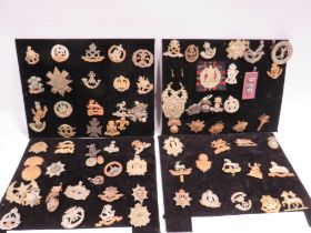 A BOX OF ASSORTED MILITARY BADGES CAP BADGES TO INCLUDE EAST YORKSHIRE , NORFOLK,, ROYAL FUSILIERS