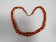 AN ART DECO STYLE AMBER FACETED BEAD NECKLACE