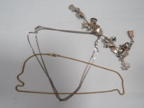 A SILVER CHARM BRACELET AND TWO SILVER NECK CHAINS