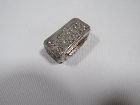 A MODERN CONTINENTAL STYLE SILVER PILL BOX, with import hallmarks, decorated with typical