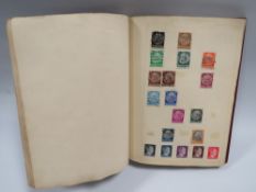 A STAMP ALBUM AND CONTENTS CONTAINING MOSTLY WORLDWIDE EXAMPLES